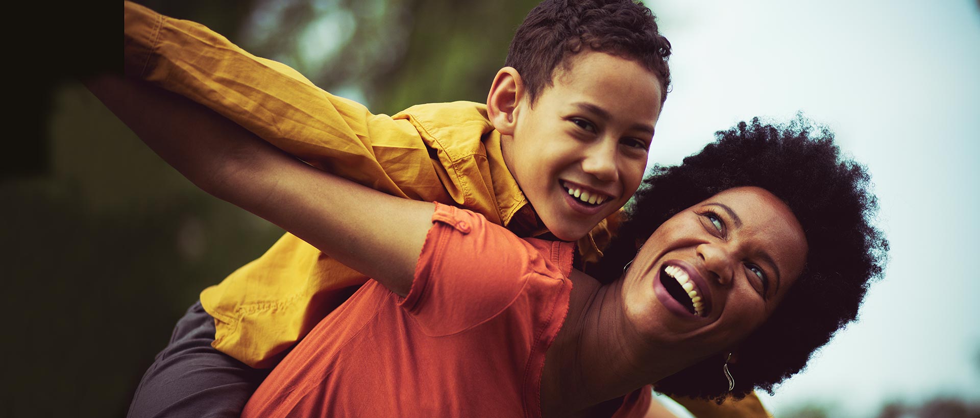 Canaan Factories Limited - Happy mother and son playing together outdoors