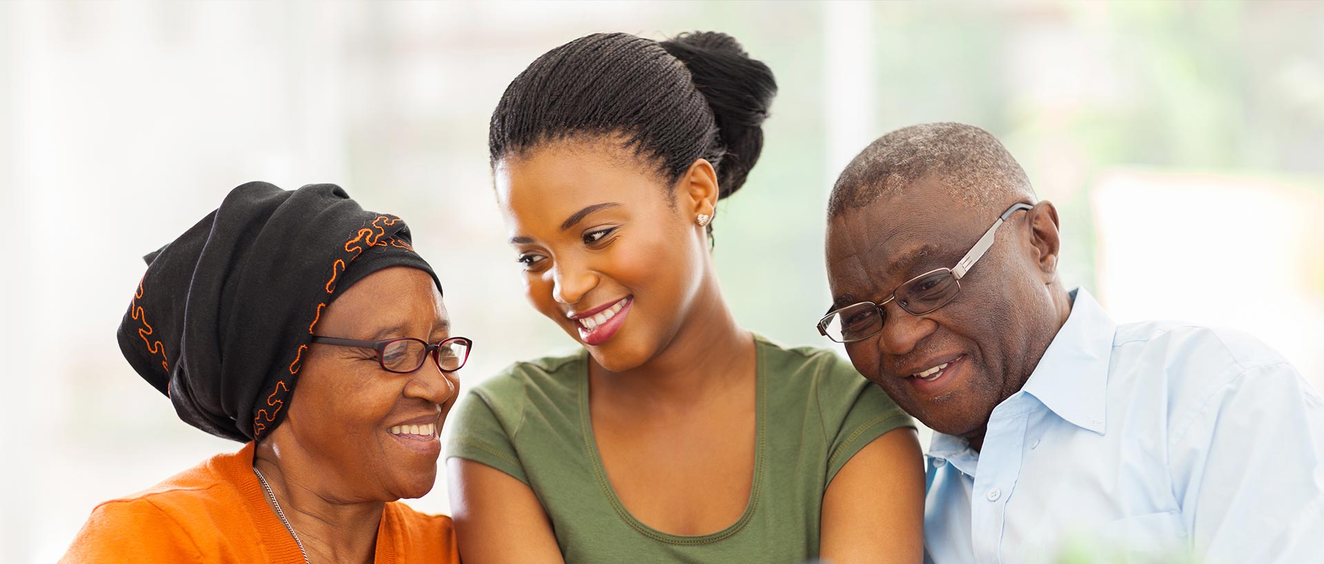 Canaan Factories Limited - Happy young woman smiling with her elderly parents